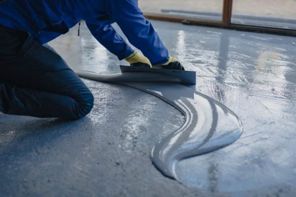 Perth Epoxy Group worker on field levelling Epoxy carpark flooring in [Location], Western Australia